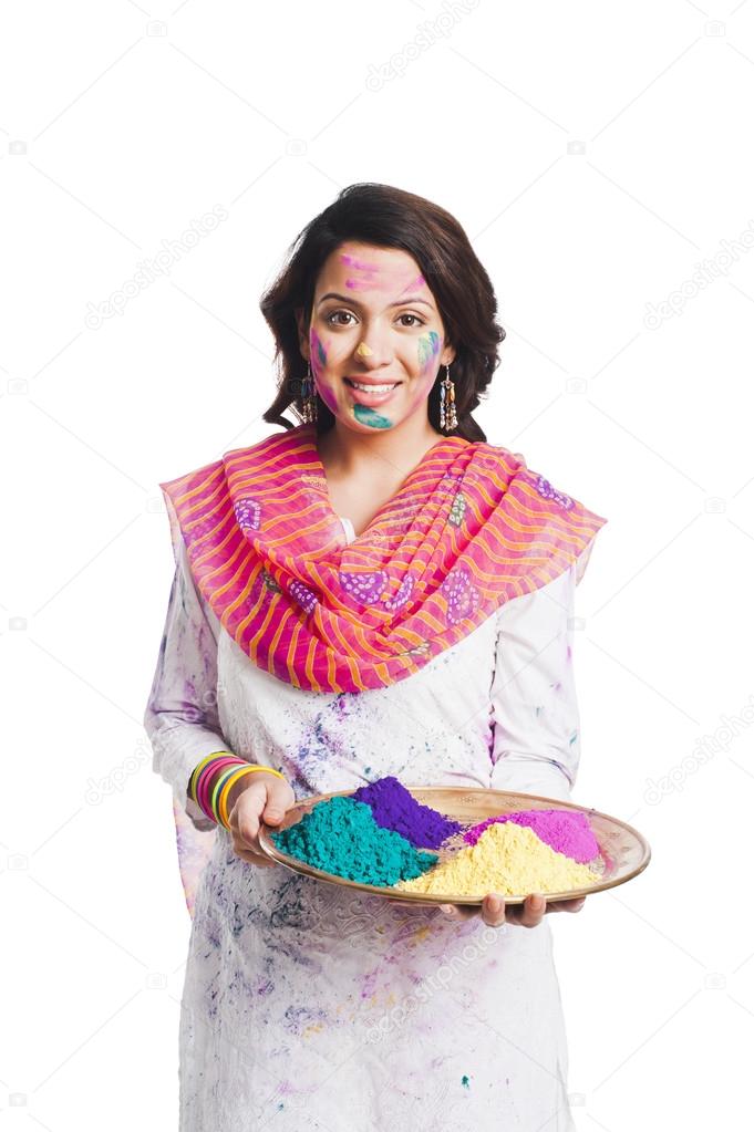 Woman holding Holi colors in a plate