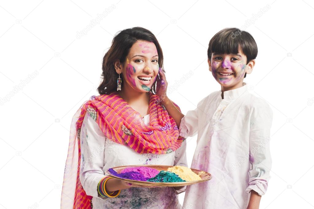 Woman celebrating Holi festival with her son