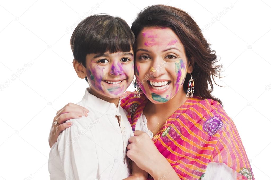 Woman with her son celebrating Holi festival