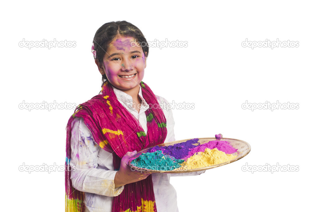 Girl holding Holi colors in a plate