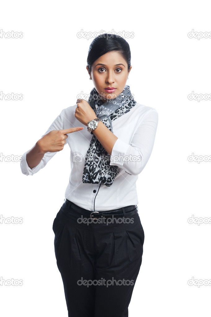 Businesswoman pointing toward a wristwatch