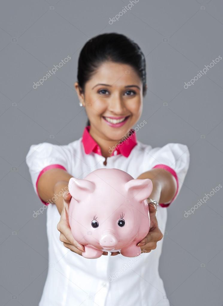 Woman holding a piggy bank