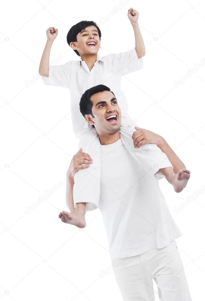Man carrying his son on shoulders