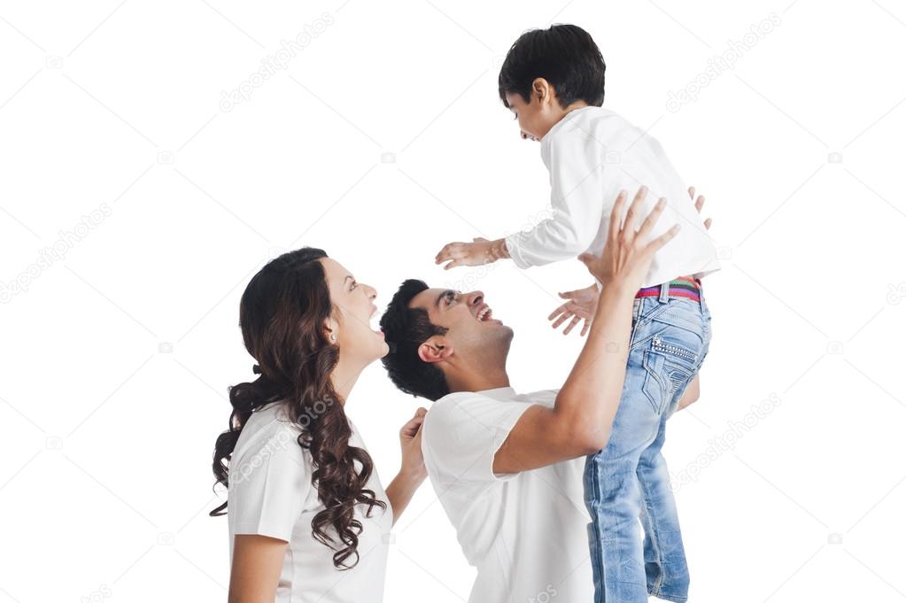 Parents playing with their son