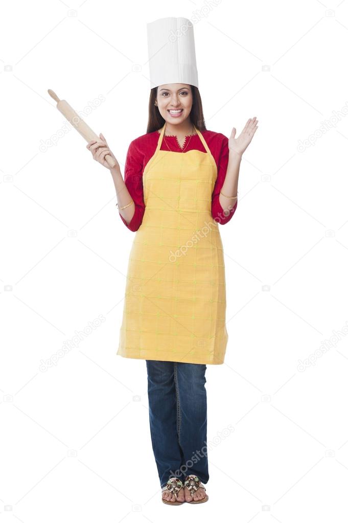 Happy woman holding a rolling pin