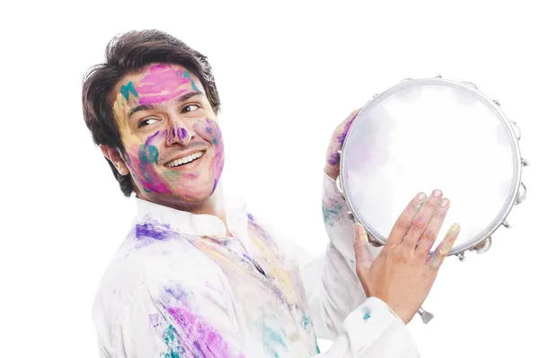 Man celebrating Holi with playing tambourine — Stock Photo, Image