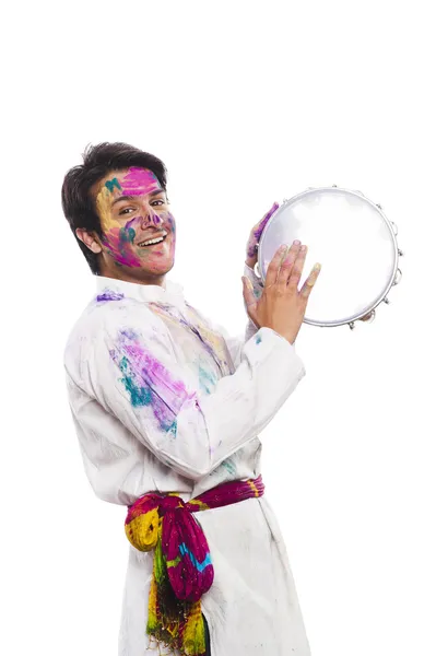 Man celebrating Holi with playing tambourine — Stock Photo, Image