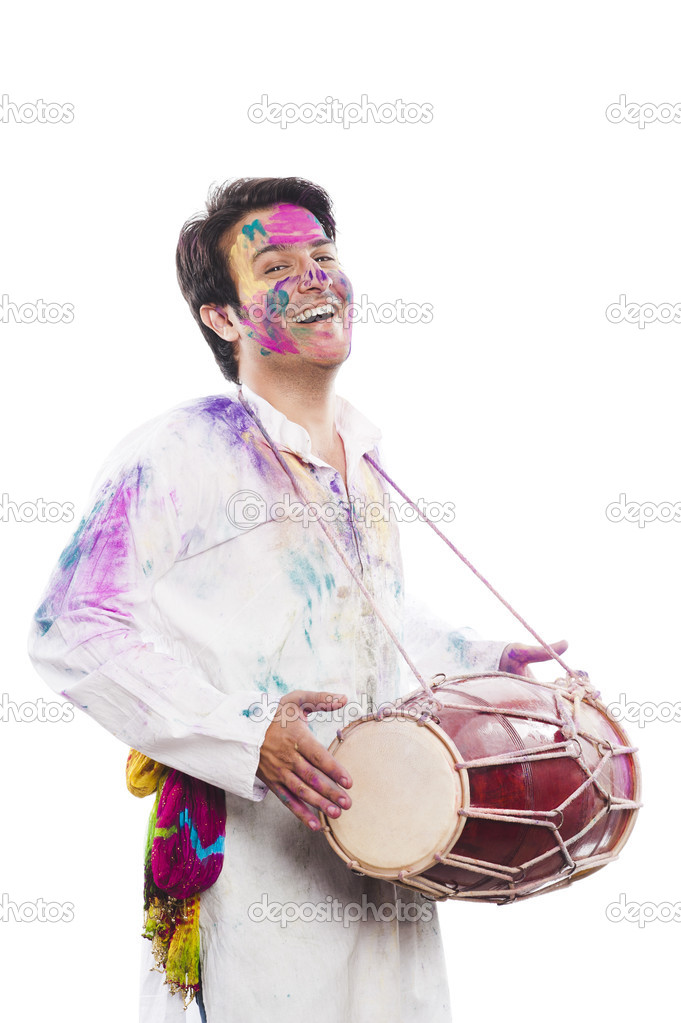 Man celebrating Holi with playing dholak