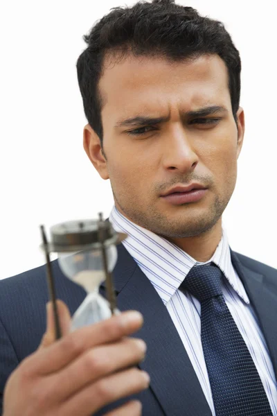 Businessman looking at an hourglass — Stock Photo, Image