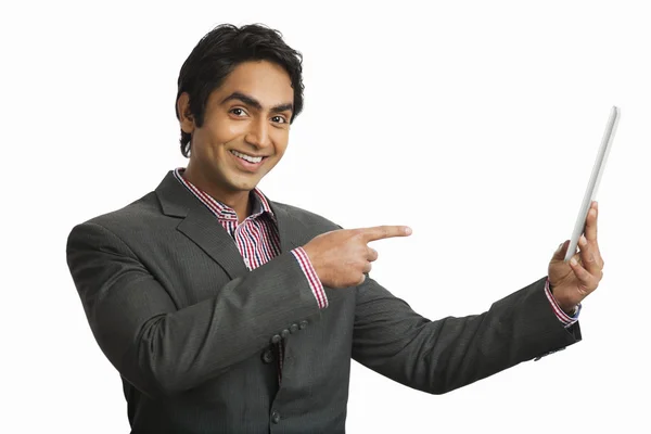 Businessman pointing at a digital tablet — Stock Photo, Image