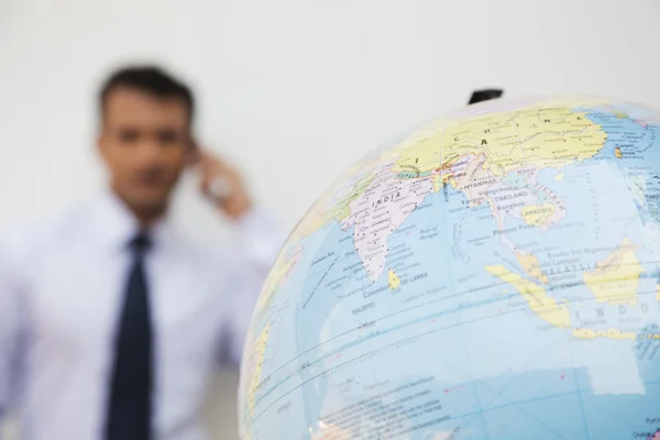 Globe with a businessman — Stock Photo, Image