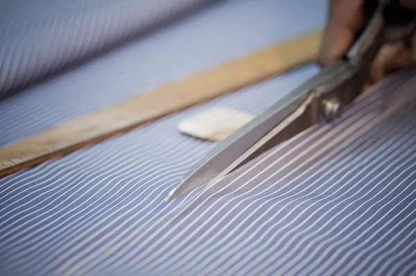 Close-up of a fabric being cut by scissors — Stock Photo, Image