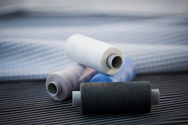 Close-up of spools of thread on a fabric — Stock Photo, Image