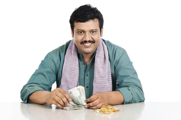 Portrait of a man counting money and smiling — Stock Photo, Image