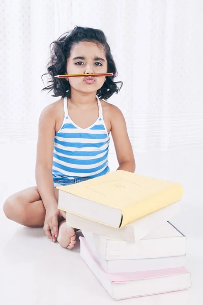 Portrait of a girl with a pencil under her nose — Stock Photo, Image