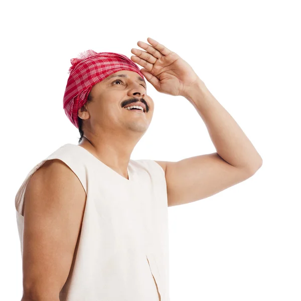 Farmer shielding his eyes — Stock Photo, Image