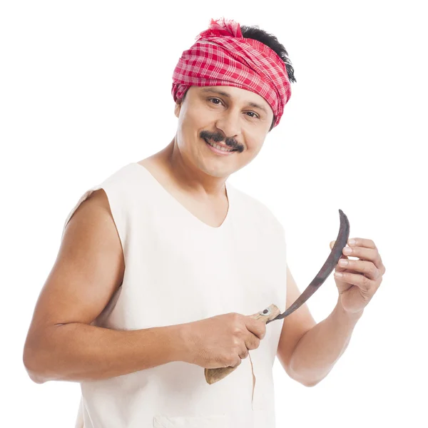 Portrait of a farmer holding a sickle and smiling — Stock Photo, Image