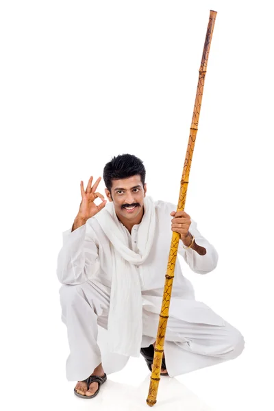 Portrait of a man holding wooden staff and gesturing — Stock Photo, Image