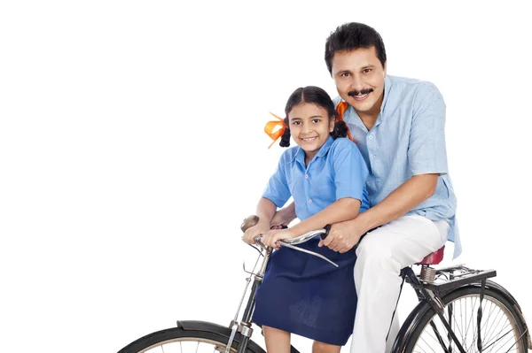 Man with his daughter on a bicycle — Stock Photo, Image