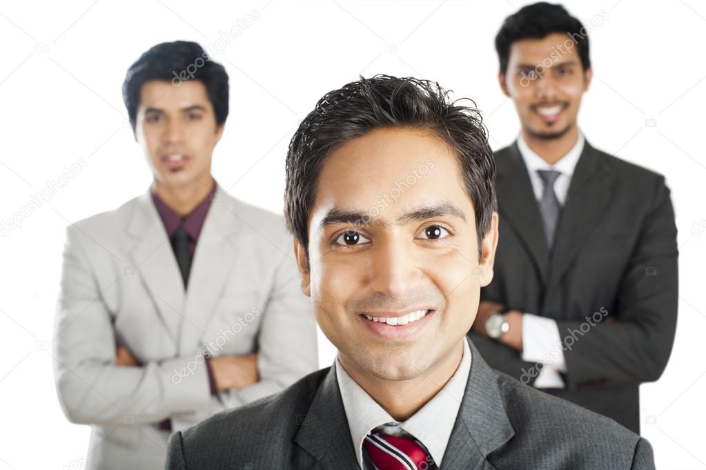 Portrait of a businessman smiling with his colleagues in the background