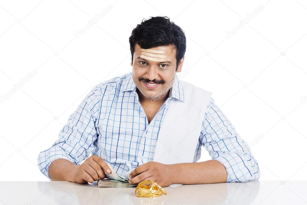 Portrait of a South Indian man counting money