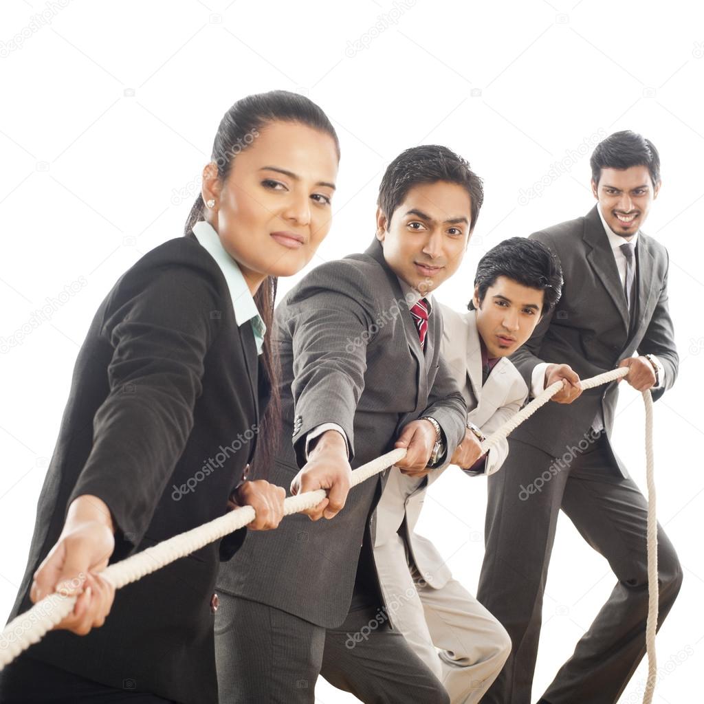 Business executives playing tug-of-war