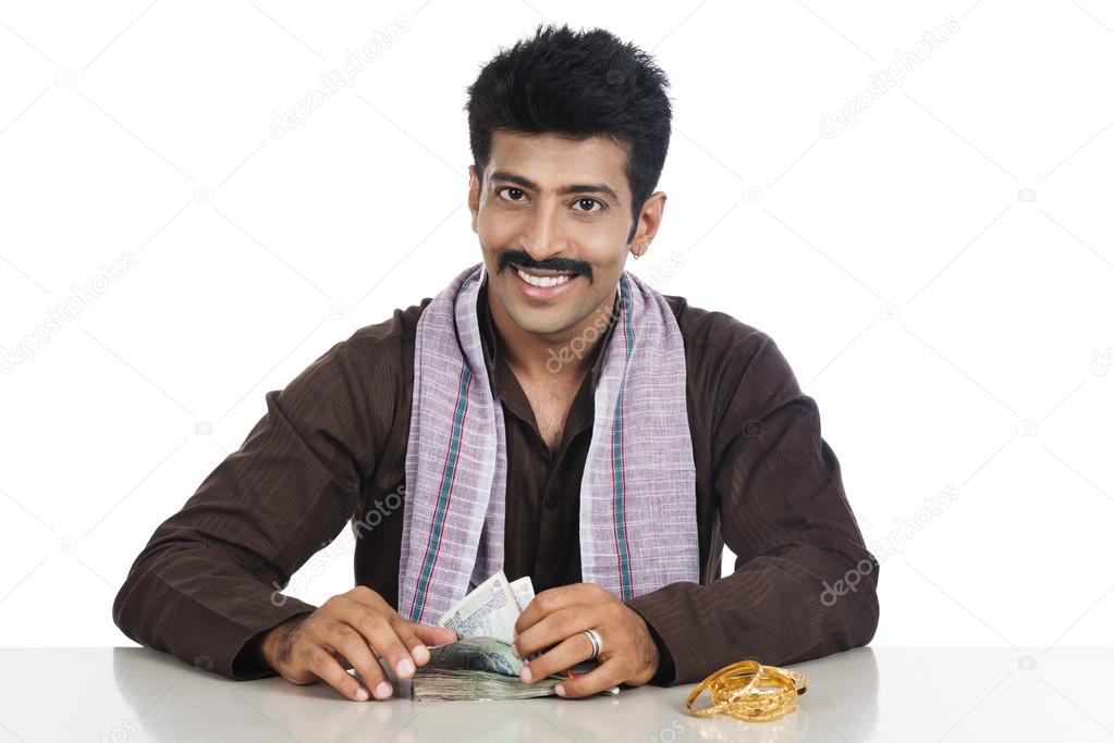 Portrait of a man counting money and smiling