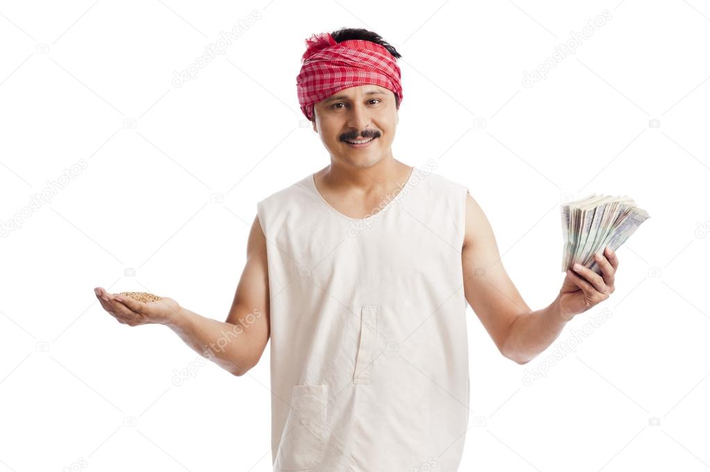 Farmer holding money in one hand and wheat in another hand