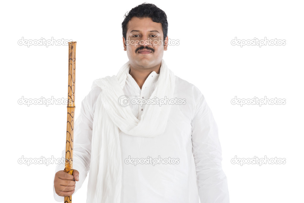 Portrait of a man holding wooden staff