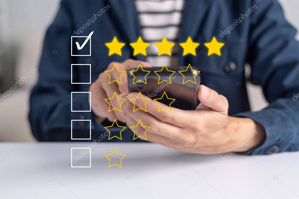 Satisfaction and customer service survey concept, business people using  smartphone. to answer the questionnaire And the satisfaction rating, the satisfaction rating with the icon 5 stars.