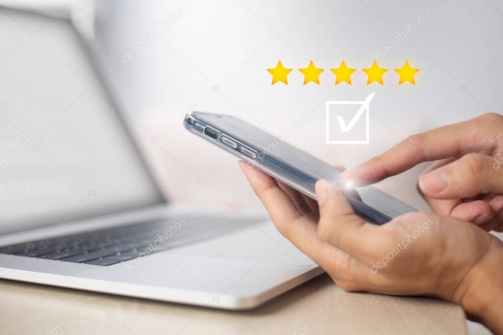 Satisfaction and customer service survey concept, business people using  smartphone. to answer the questionnaire And the satisfaction rating, the satisfaction rating with the  icon 5 stars.