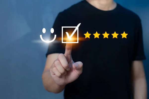 Satisfaction and customer service survey concept, business people using virtual screen. to answer the question And the satisfaction rating, the satisfaction rating with the smiley face icon 5 stars.