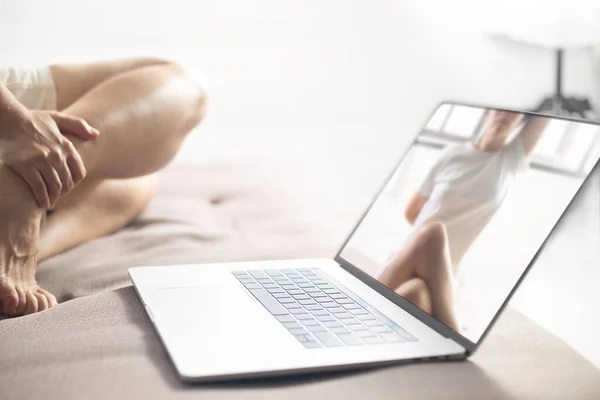 Women using laptop learning yoga at home via yoga online training. Woman studying yoga at home via videoconferencing. women start to practice meditation.