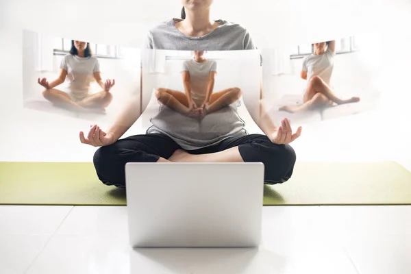 Women using laptop learning yoga at home via yoga online training. Woman studying yoga at home via videoconferencing. women start to practice meditation.