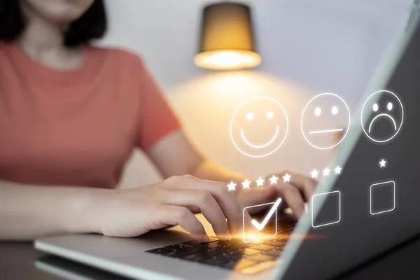 Satisfaction and customer service survey concept, business people using  laptop. to answer the questionnaire And the satisfaction rating, the satisfaction rating with the smiley face icon 5 stars.