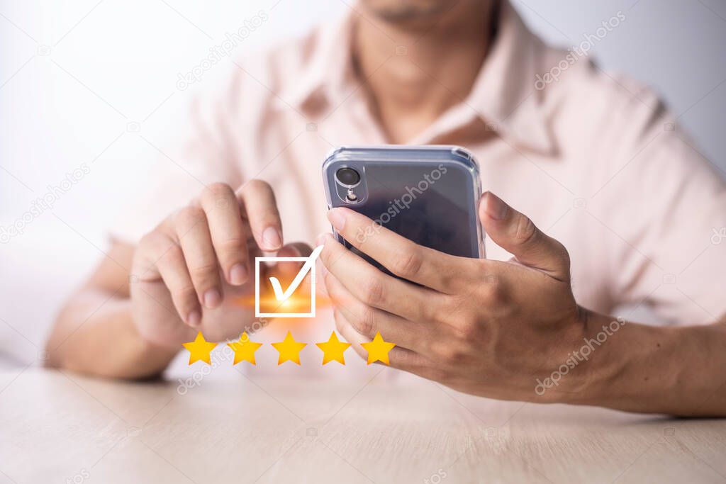 Satisfaction and customer service survey concept, business people using  smartphone. to answer the questionnaire And the satisfaction rating, the satisfaction rating with the icon 5 stars.