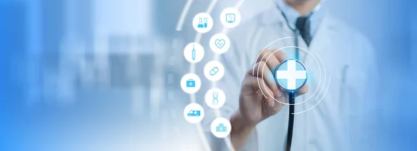Doctor with stethoscope touching on medical icons. Medical technology icons virtual screen. Health care and medical technology services concept.