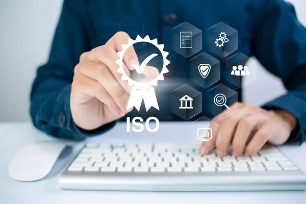 ISO Certification of standards quality control assurance business technology concept. Businessman using virtual screen iso certification icon to guarantee.