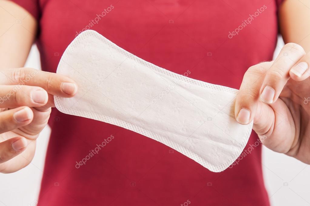 Young woman holding menstrual pad