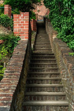 Staircase with brick walls in a park in the evening light.