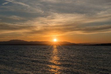 Calm sunset over a coastal mountain range in Croatia.