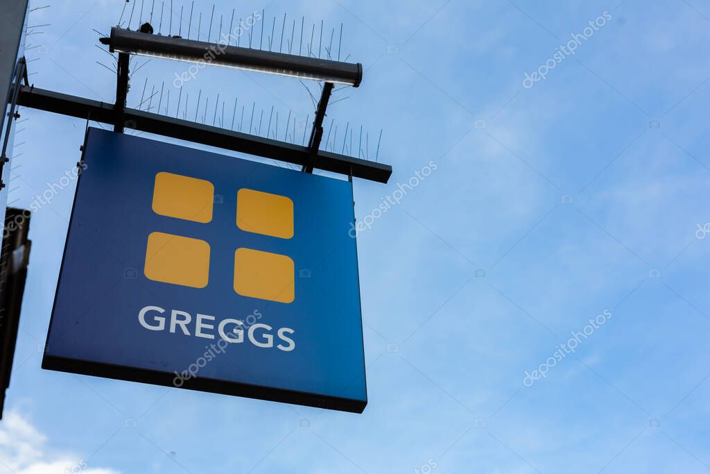 Felixstowe Suffolk UK September 17 2021: Greggs store logo front of shop isolated against a clear blue summer sky