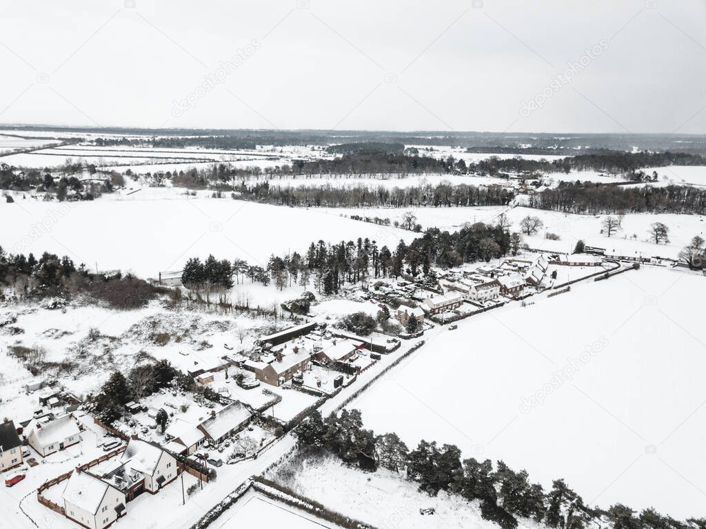 Aerial view of a small village in the British countryside during a rare heavy snowfall known as the beast from the east