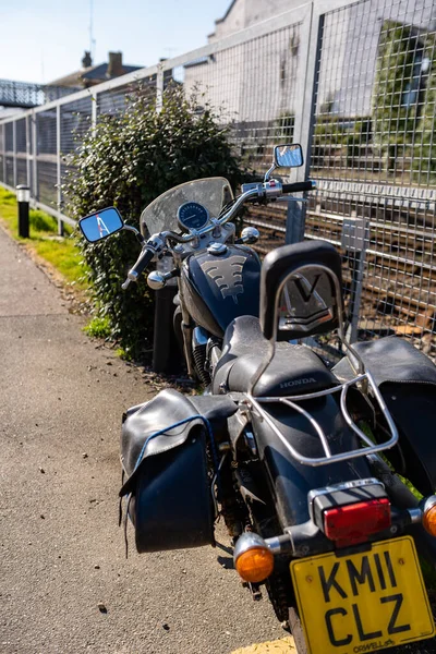 Woodbridge Suffolk İngiltere 18 Mart 2022: 2011 model bir HONDA VT 750 SA motosikleti açık mavi gökyüzüne karşı açık bir bahar güneşinde bir yolda oturuyor