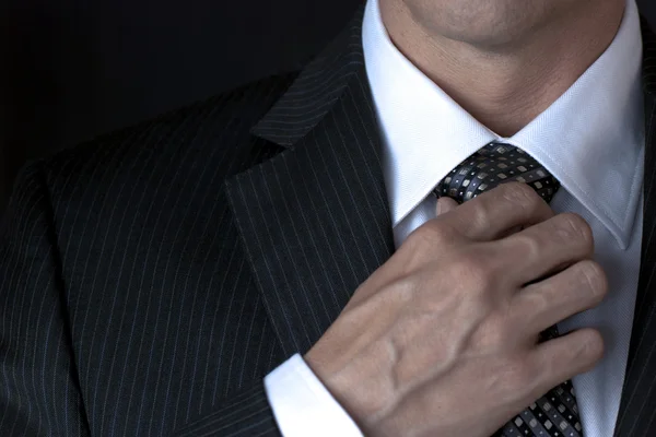 Businessman Adjusting Tie With Right Hand — Stock Photo, Image