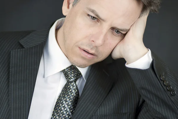 Defeated Businessman Looks Down While Holding Head In Hand — Stock Photo, Image