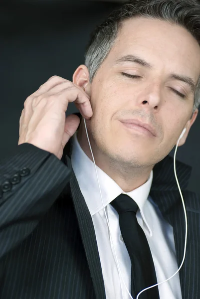 Serene Businessman Puts In Headphones — Stock Photo, Image