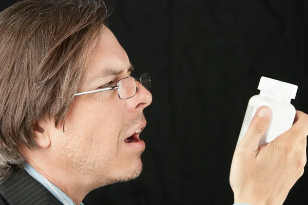 Casual Businessman Wearing Reading Glasses Trying To Read Pill B — Stock Photo, Image