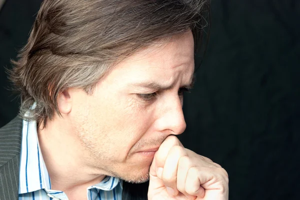 Worried Businessman Presses His Fist To Mouth, Side View — Stock Photo, Image