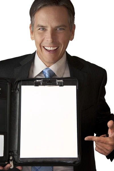 Smiling Businessman Points To Binder Contents — Zdjęcie stockowe